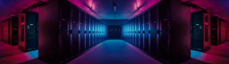 Data center servers behind glass with purple neon light shining